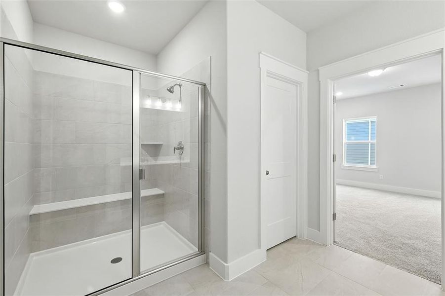 Bathroom featuring a shower stall, light tile patterned floors, and recessed lighting