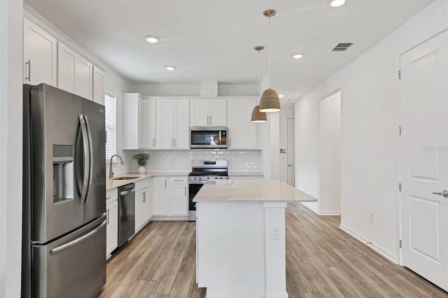 Neutral white subway tile backsplash allows for seasonal pops of color in the kitchen