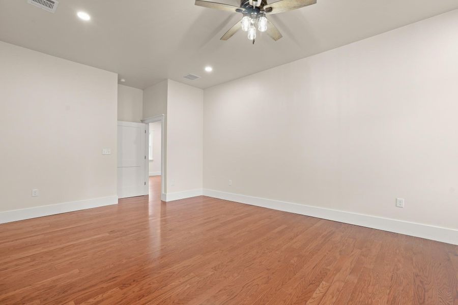 Natural light illuminates rich hardwood floors, creating a warm and inviting atmosphere. Natural light illuminates rich hardwood floors, creating a warm and inviting atmosphere.