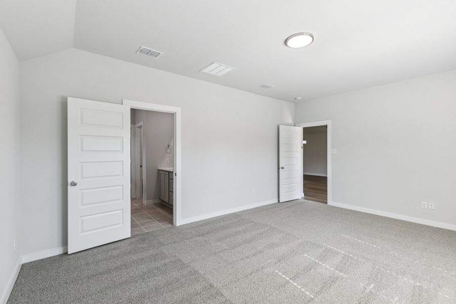 Primary Suite in the Oscar home plan by Trophy Signature Homes – REPRESENTATIVE PHOTO