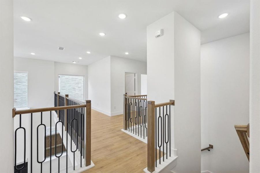 Corridor with light hardwood / wood-style floors