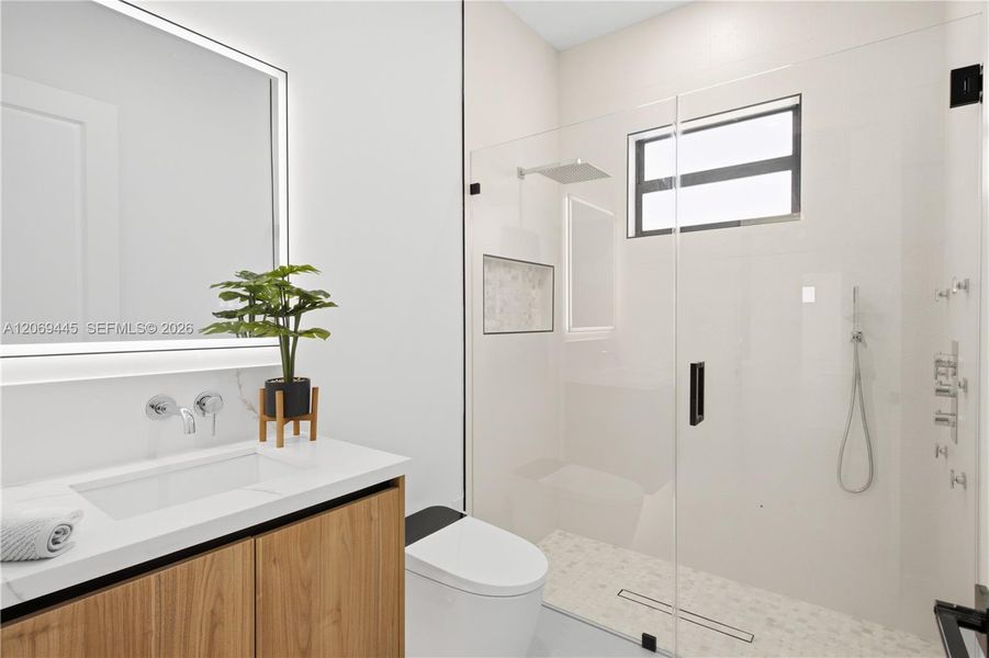 Convenient hallway bathroom features modern finishes and a clean contemporary design. Convenient hallway bathroom features modern finishes and a clean contemporary design.
