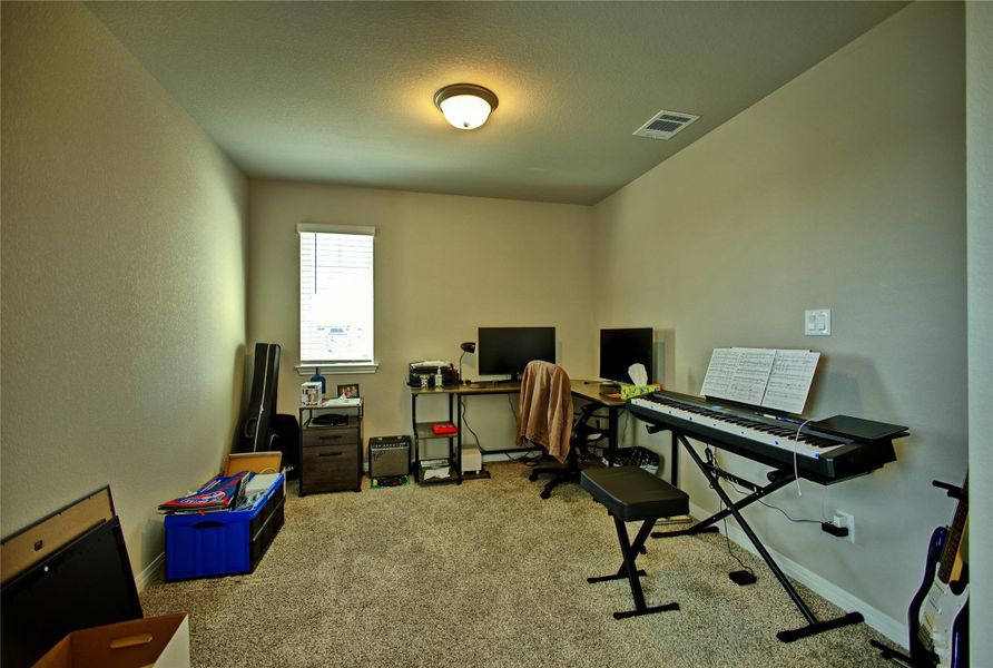 Office space with light colored carpet and a textured ceiling Office space with light colored carpet and a textured ceiling