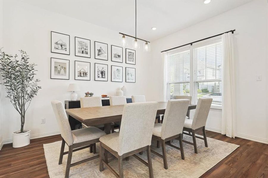 Dining space with dark wood-type flooring