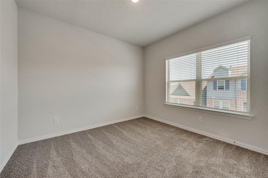 Carpeted spare room with plenty of natural light