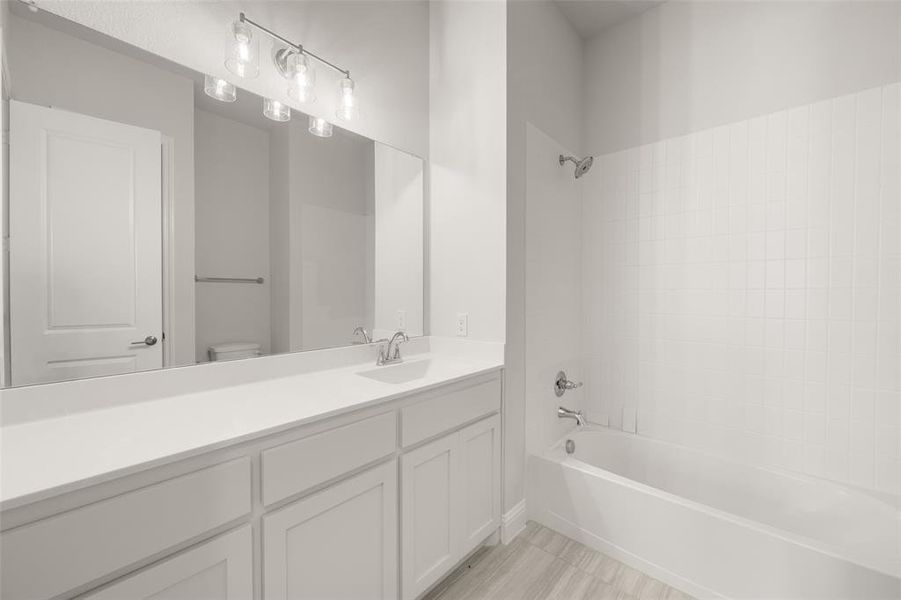 Full bathroom featuring tub / shower combination and vanity Full bathroom featuring tub / shower combination and vanity