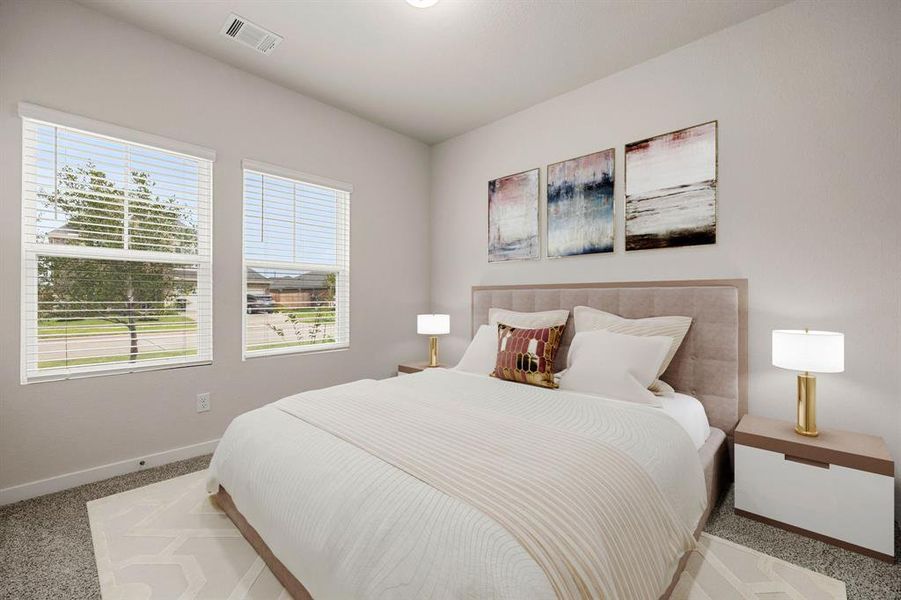 Secondary bedroom great for use as an in-law suite or guest suite features high ceilings, lovely neutral paint, plush carpet, direct access to the secondary bathroom and large windows with privacy blinds.