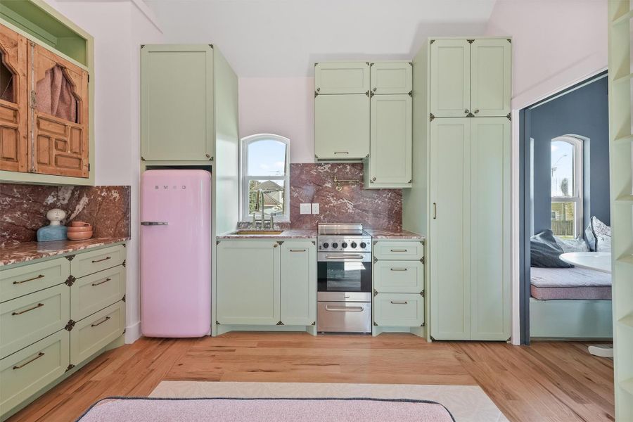 Tiny but mighty kitchen. Plenty of storage and equipped with a stove and Smeg refrigerator.