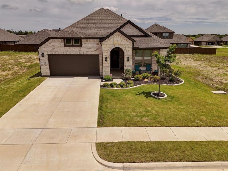 Front exterior of a new home in , Venus, TX, highlighting curb appeal (Image 22).
