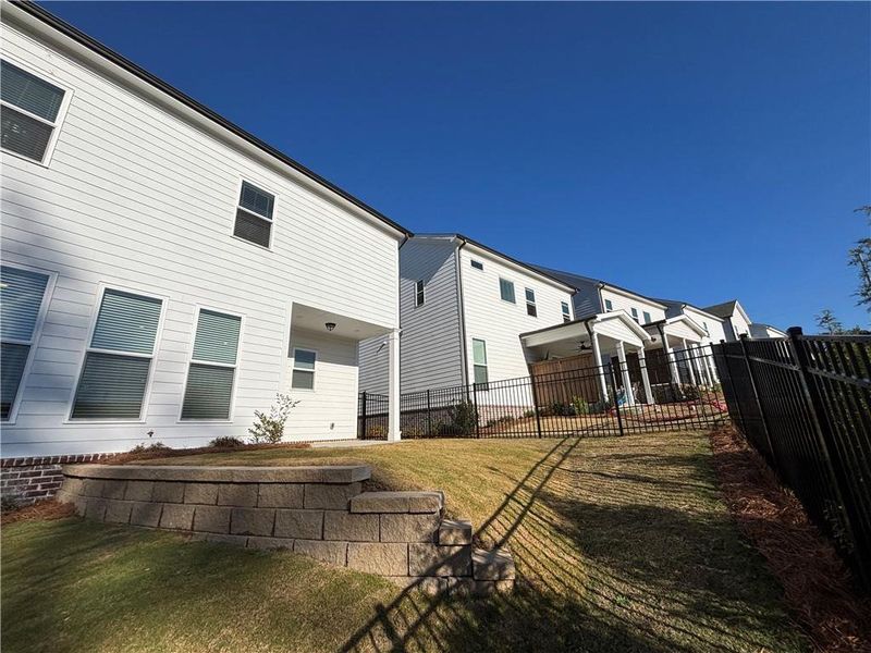 Exterior details and patio area of a home in Palisades Single Family, Cumming (Image 25).