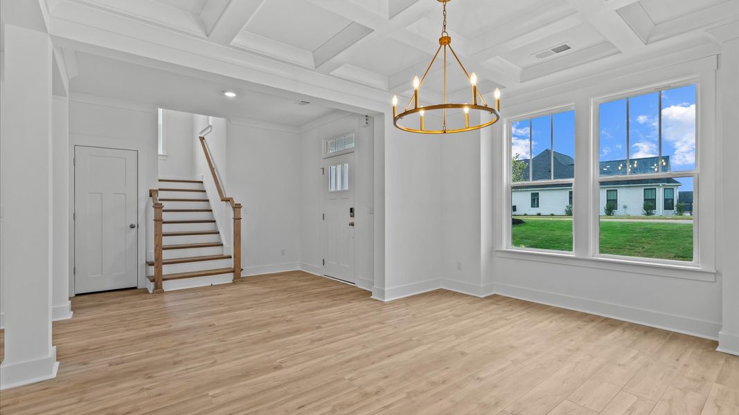Eye-catching coffered ceiling adds charm to the formal dining space in this superior DRB Homes design
