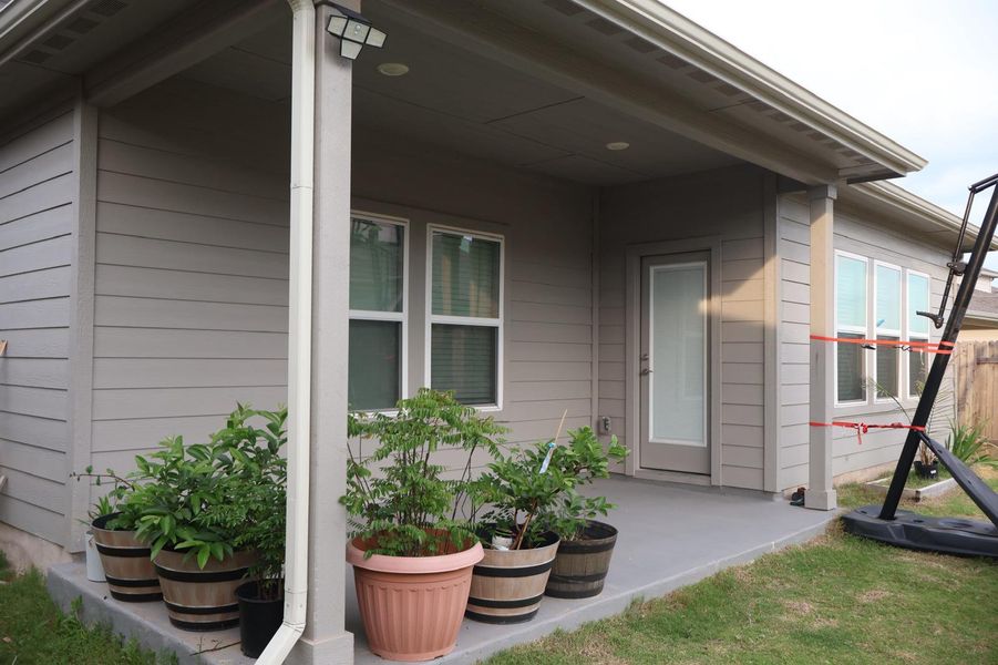 A well-maintained covered patio extends outdoor living space, perfect for tranquil moments.