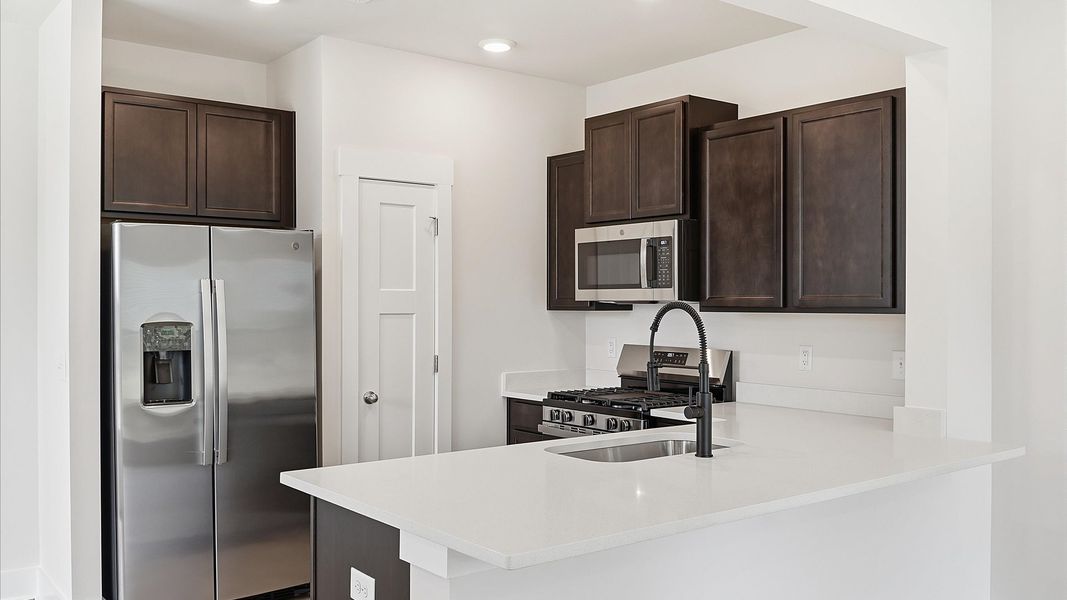 Beautifully appointed kitchen with spacious counters and sophisticated detailing at Clarke Townes