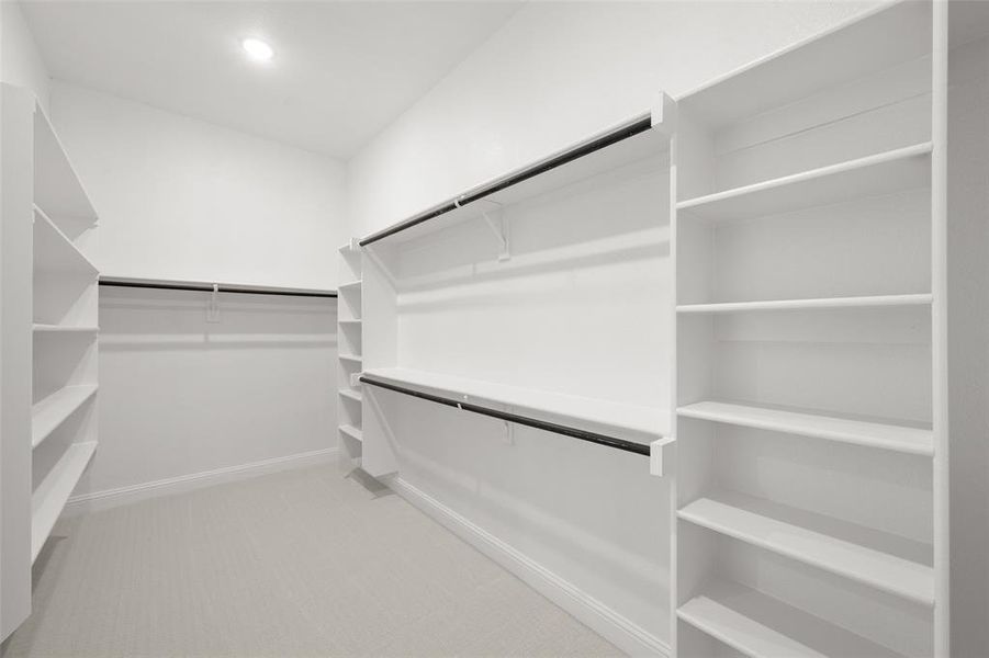 Master closet with plenty of hanging space and shelving!