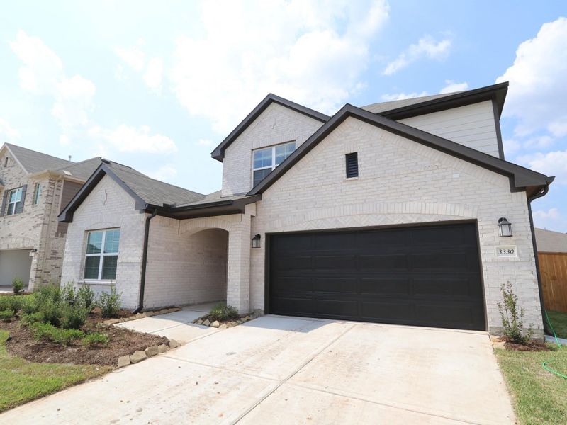 Front exterior of a new home in Miller's Pond, Rosenberg, TX, highlighting curb appeal (Image 2).