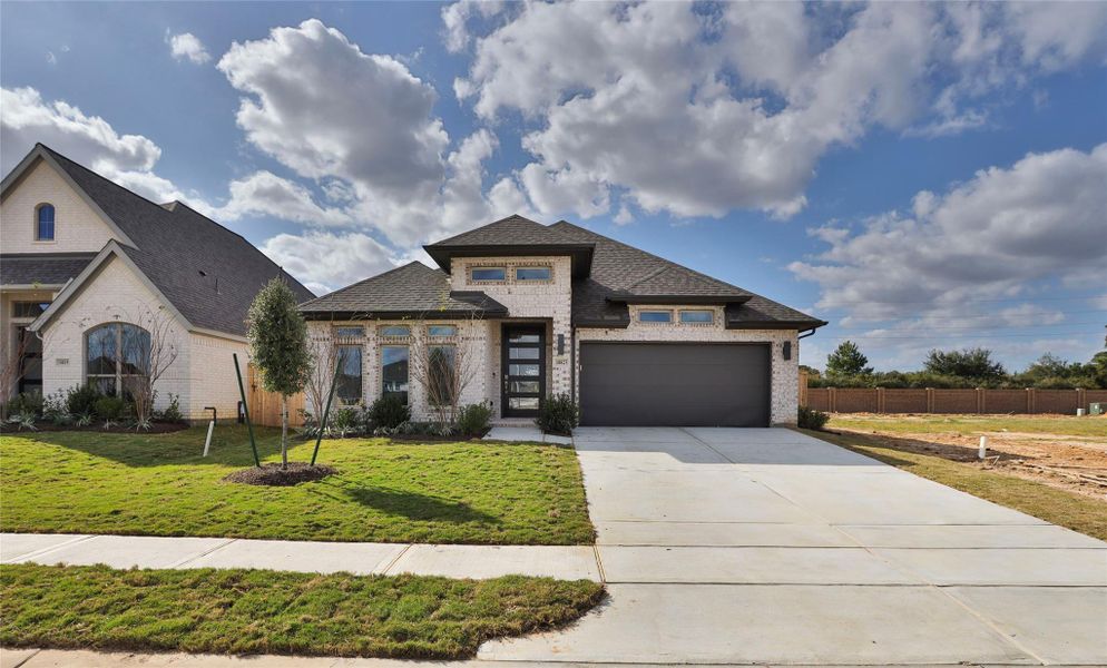 Front exterior of a new home in Everly 50', Tomball, TX, highlighting curb appeal (Image 1).