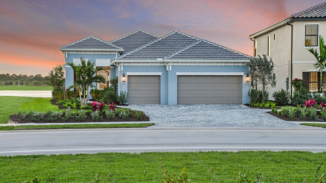 Front exterior of a new home in SkySail Real Estate and Homes for Sale in Naples, FL - Neal Communities, Naples, FL, highlighting curb appeal (Image 22). Front exterior of a new home in SkySail Real Estate and Homes for Sale in Naples, FL - Neal Communities, Naples, FL, highlighting curb appeal (Image 22).