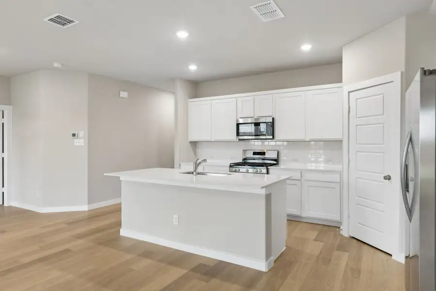 Kitchen in the Emmy II home plan by Trophy Signature Homes - REPRESENTATIVE PHOTO