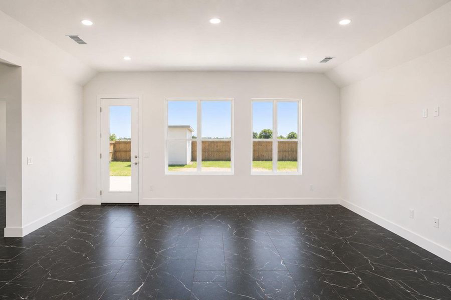 A versatile living space with sleek flooring and ample natural light awaits your personal touch.
