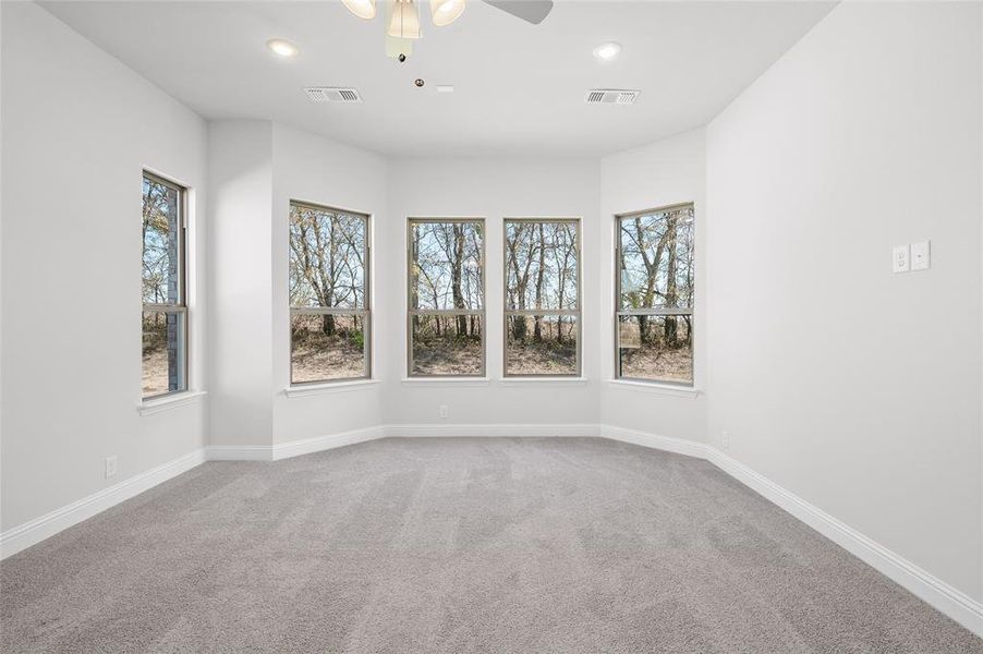 Unfurnished room with light colored carpet, ceiling fan, and recessed lighting Unfurnished room with light colored carpet, ceiling fan, and recessed lighting