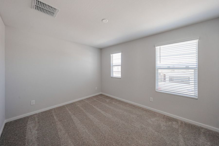 A room with a window and a carpet. A room with a window and a carpet.