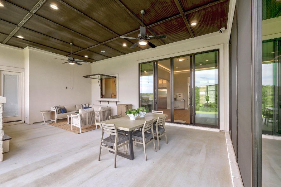 An inviting outdoor patio, perfect for relaxing and entertaining, features a dining area and lounge space.