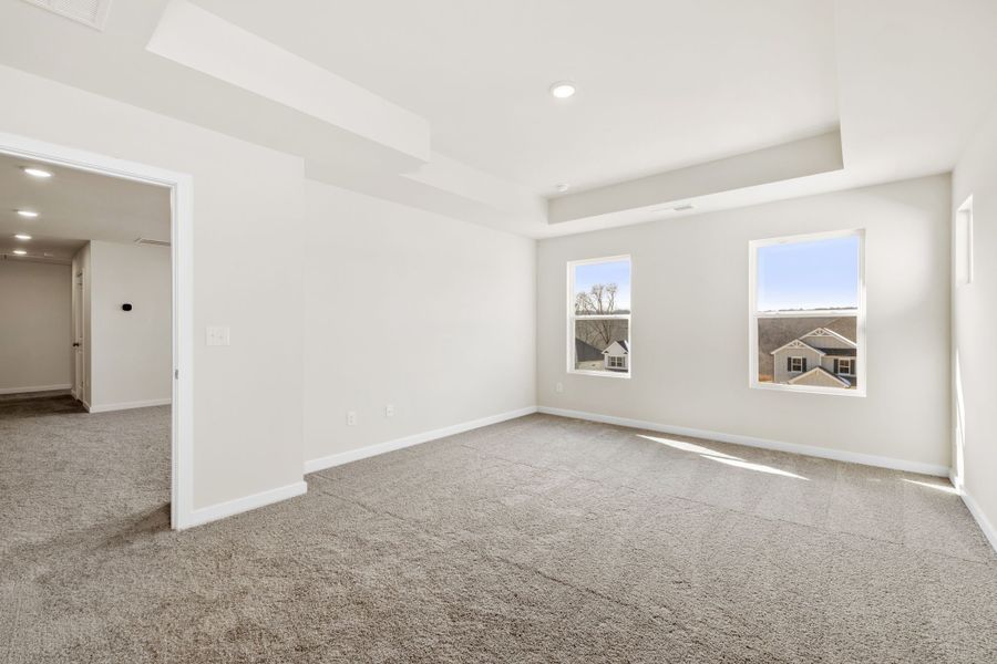 A room with a carpet and a few paintings on the wall. A room with a carpet and a few paintings on the wall.