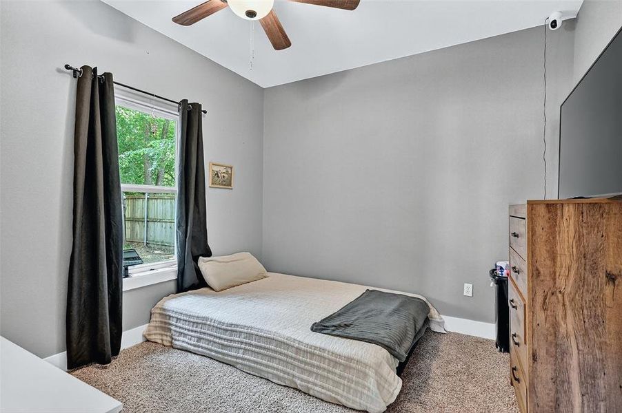 Carpeted bedroom featuring baseboards and ceiling fan Carpeted bedroom featuring baseboards and ceiling fan