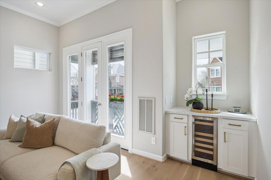 Dry bar/coffee area featuring Carrera countertop, beverage cooler and custom cabinets.