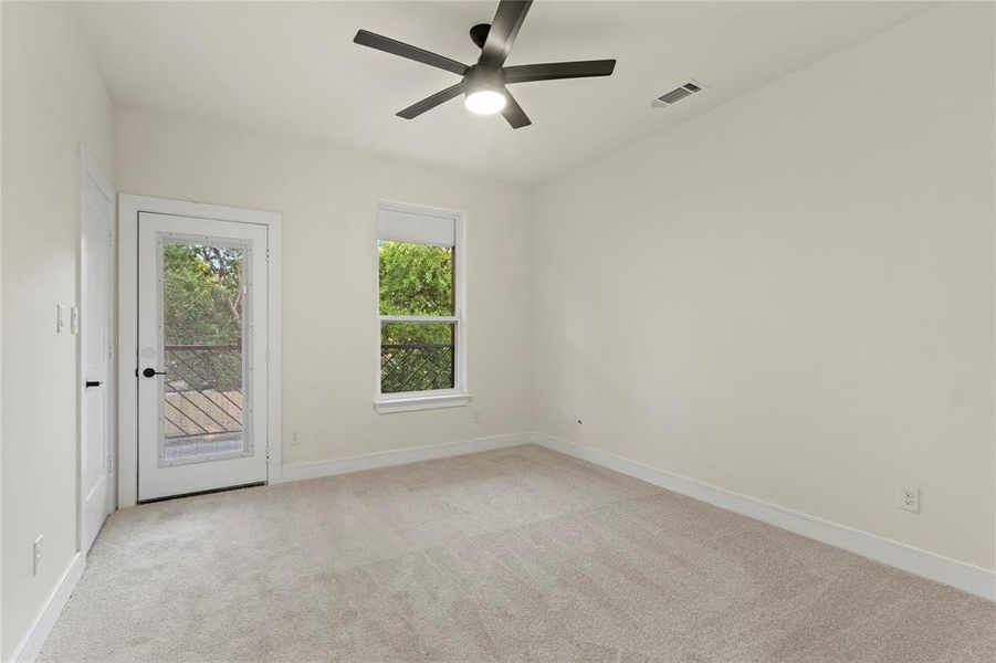 Empty room with light carpet and ceiling fan Empty room with light carpet and ceiling fan