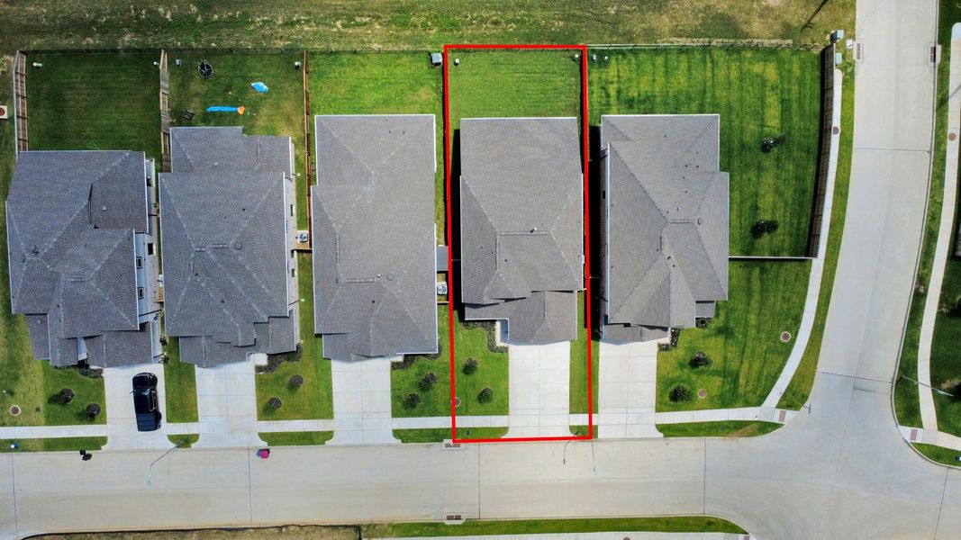 An aerial view of a spacious subdivision lot, highlighting a well-maintained yard and a fully fenced perimeter, offering both privacy and expansive outdoor space. An aerial view of a spacious subdivision lot, highlighting a well-maintained yard and a fully fenced perimeter, offering both privacy and expansive outdoor space.