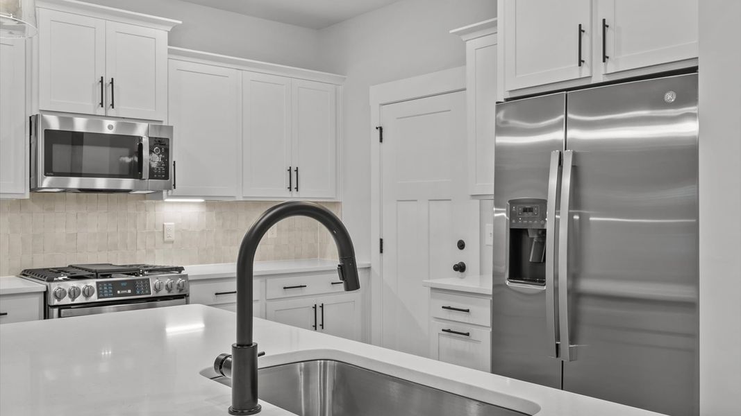 Tasteful design meets functional luxury in this kitchen with a 7-foot island and modern pendant lighting Tasteful design meets functional luxury in this kitchen with a 7-foot island and modern pendant lighting