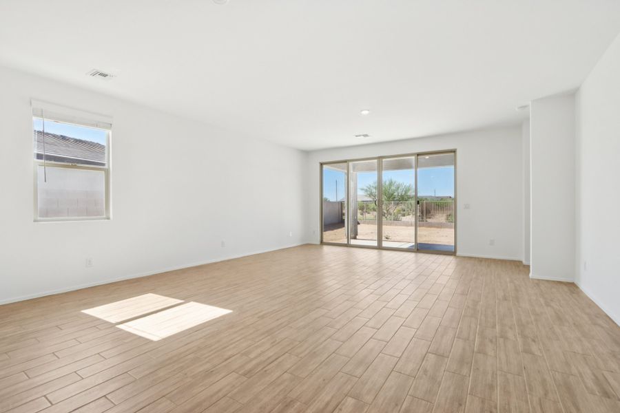 Great room with upgraded 4 panel slider. Finishes and options may vary by community