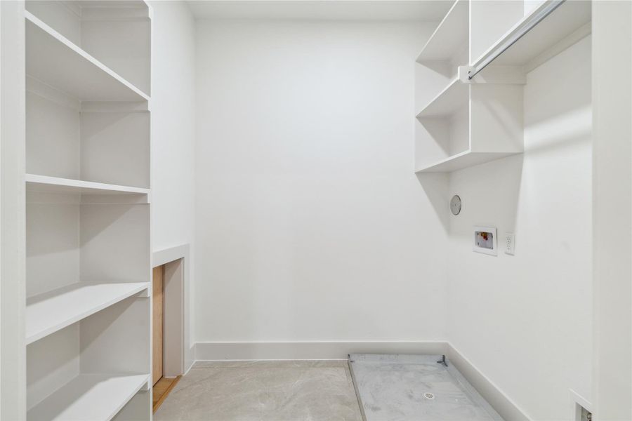 A dedicated laundry room with custom built-ins and hanging storage makes laundry day feel a little more luxe—and a lot more organized.