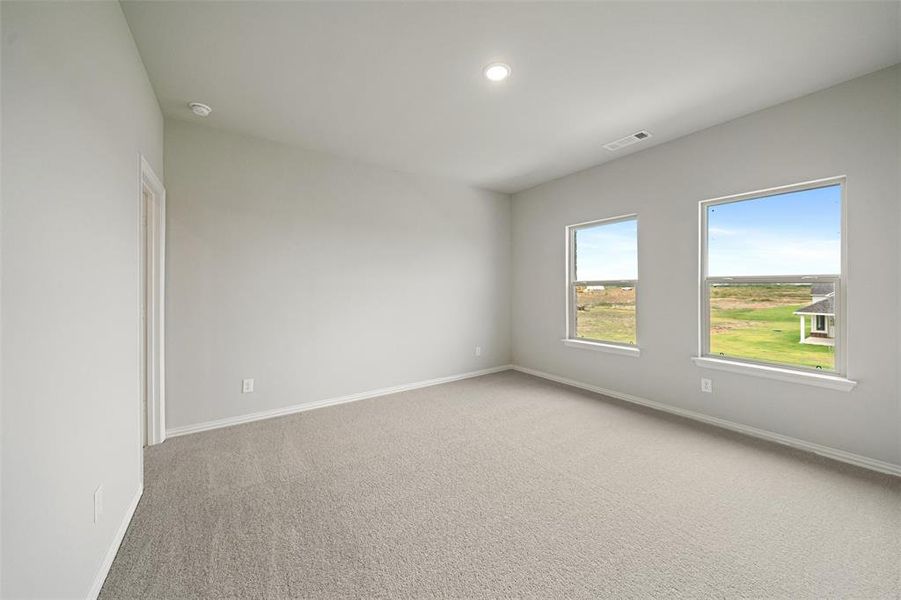 Unfurnished room with light colored carpet and recessed lighting Unfurnished room with light colored carpet and recessed lighting