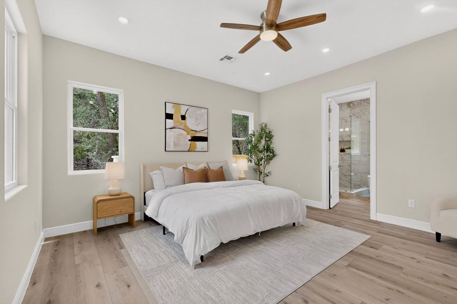 Smooth wood floors and recessed lighting anchor this calm, modern main-level retreat.