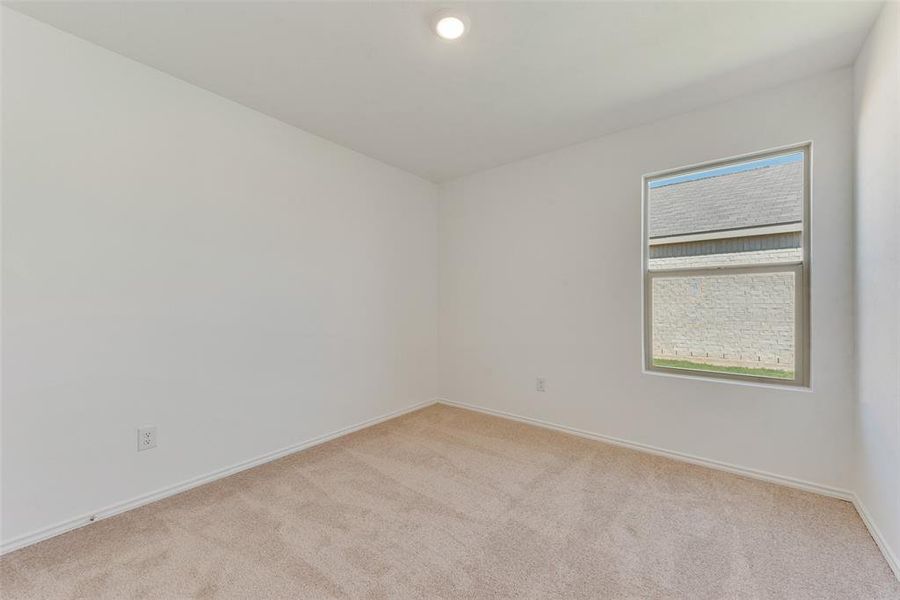 Carpeted empty room with a wealth of natural light