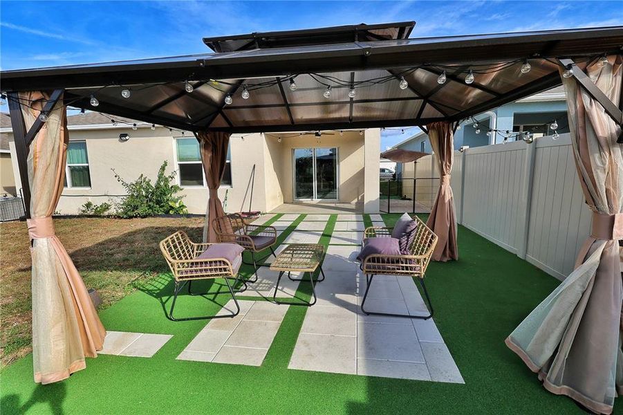 Exterior details and patio area of a home in Forest Lake, Davenport (Image 25).
