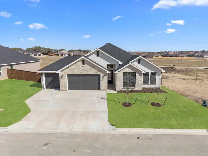 Front exterior of a new home in Bella Charca, Nolanville, TX, highlighting curb appeal (Image 1). Front exterior of a new home in Bella Charca, Nolanville, TX, highlighting curb appeal (Image 1).