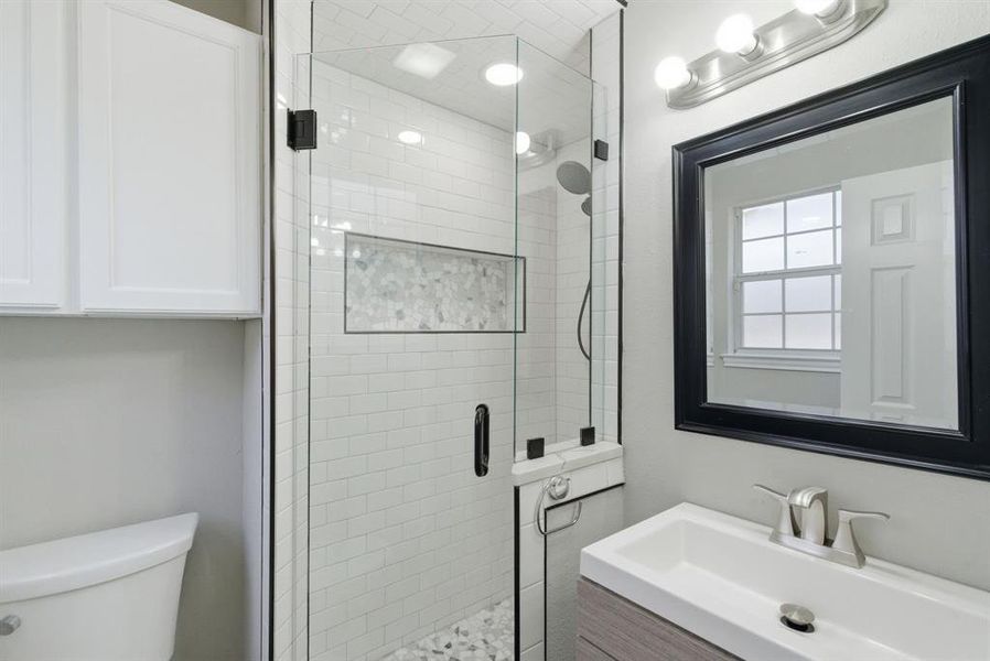 Full bathroom with a stall shower and vanity Full bathroom with a stall shower and vanity