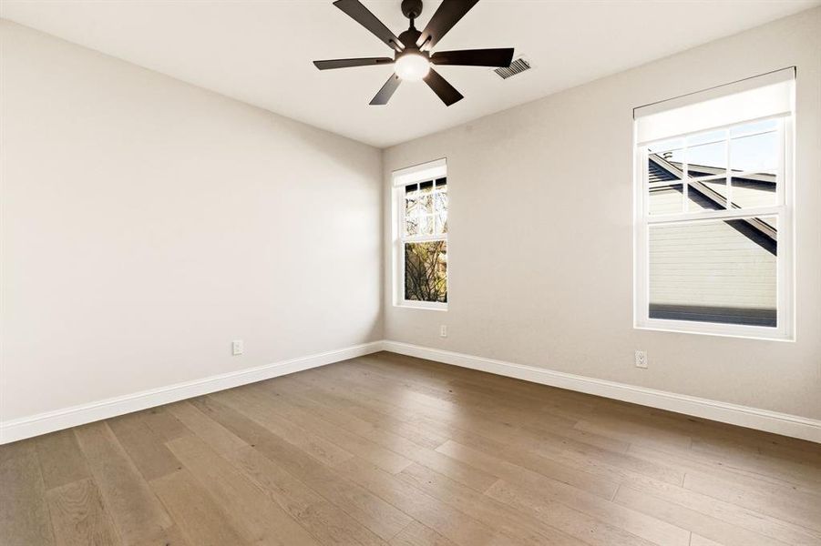 Unfurnished room with light wood finished floors and ceiling fan
