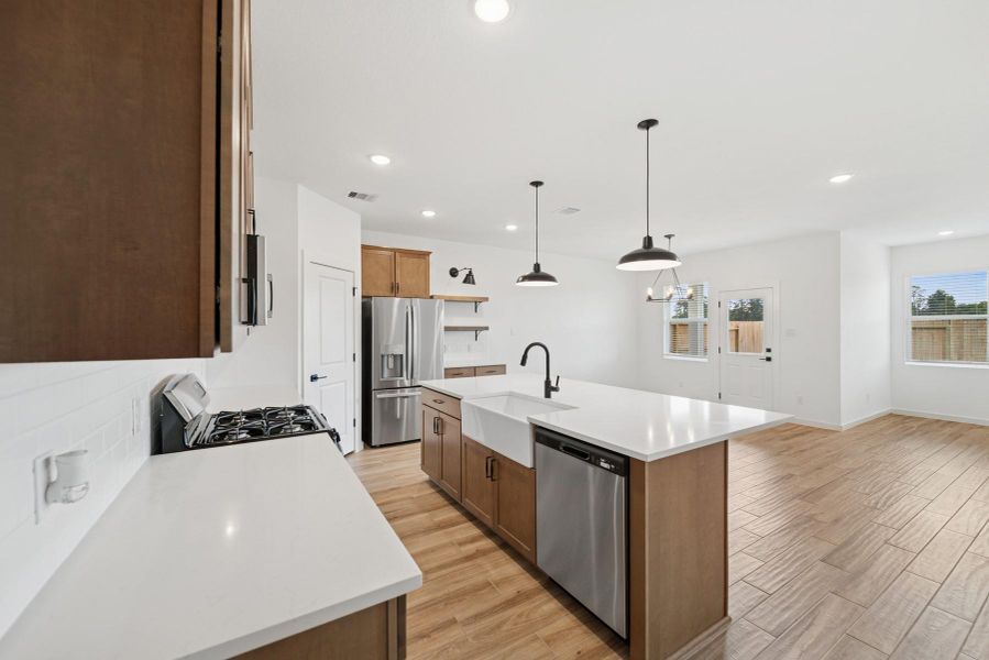 Lovely kitchen with light stain cabinets and quartz countertops Lovely kitchen with light stain cabinets and quartz countertops