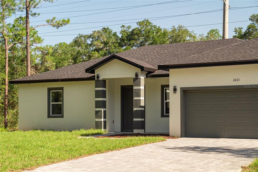 Front exterior of a new home in , Citrus Springs, FL, highlighting curb appeal (Image 24).