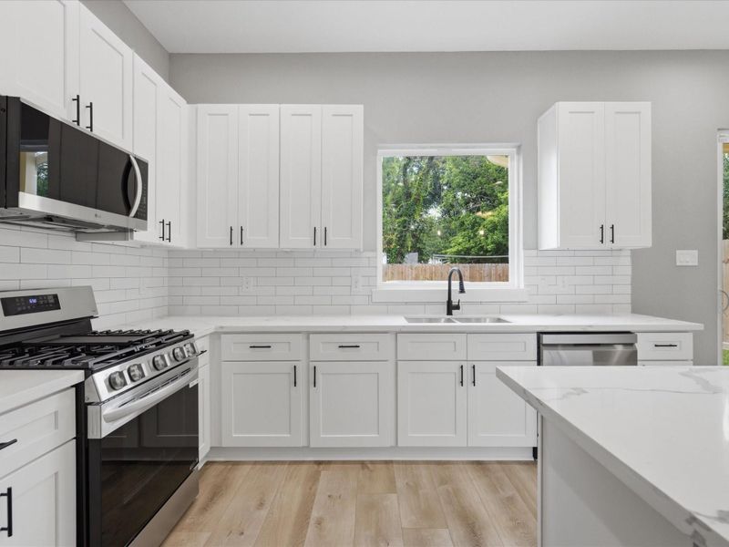 Designed to be both beautiful and functional, the kitchen offers modern finishes, abundant storage, and a seamless connection to the home's living spaces. Designed to be both beautiful and functional, the kitchen offers modern finishes, abundant storage, and a seamless connection to the home's living spaces.