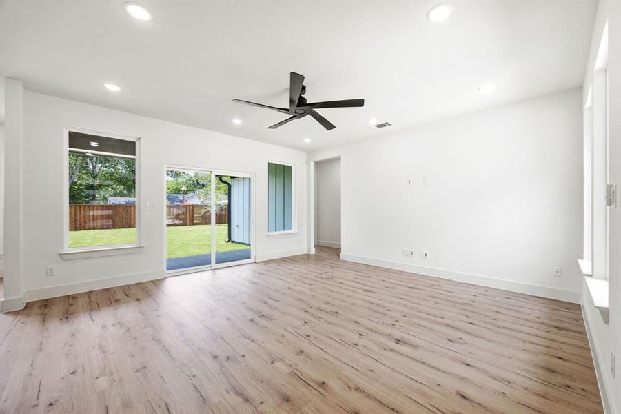 Empty room featuring light wood finished floors, a ceiling fan, recessed lighting, and baseboards Empty room featuring light wood finished floors, a ceiling fan, recessed lighting, and baseboards