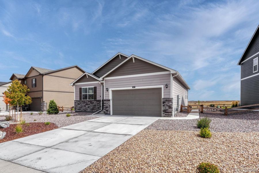 Front exterior of a new home in Spring Valley Ranch, Elizabeth, CO, highlighting curb appeal (Image 22).