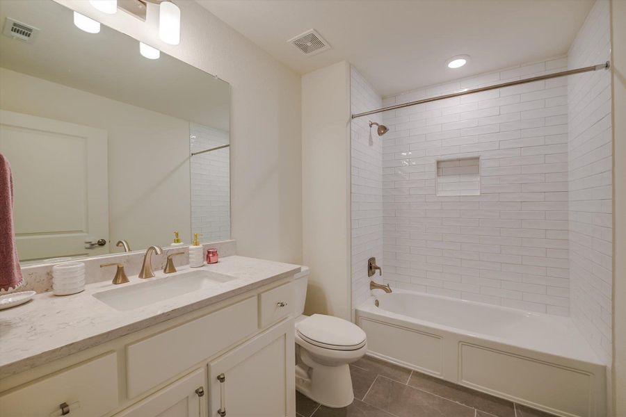 Full bath with vanity, tub / shower combination, tile patterned floors, and recessed lighting Full bath with vanity, tub / shower combination, tile patterned floors, and recessed lighting