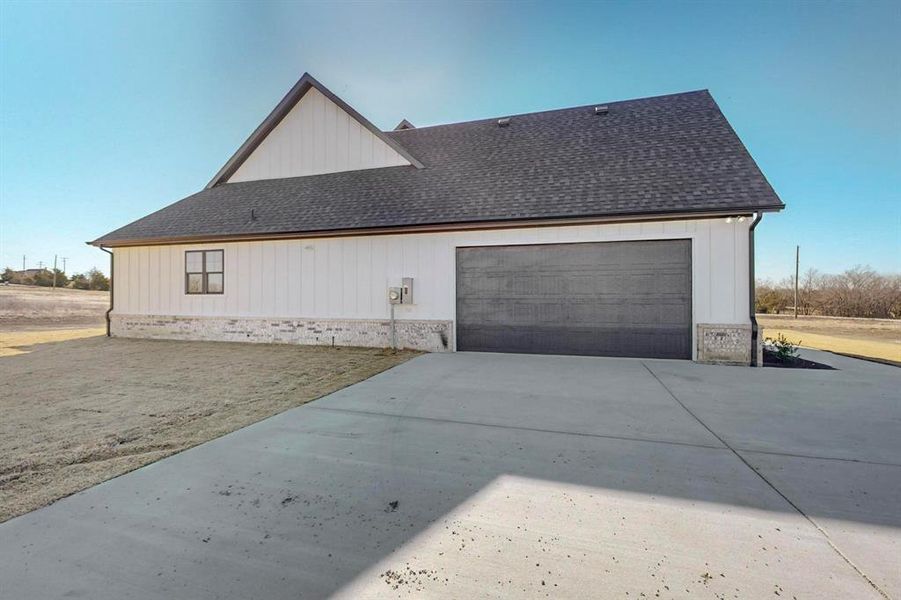 View of side of property featuring a garage