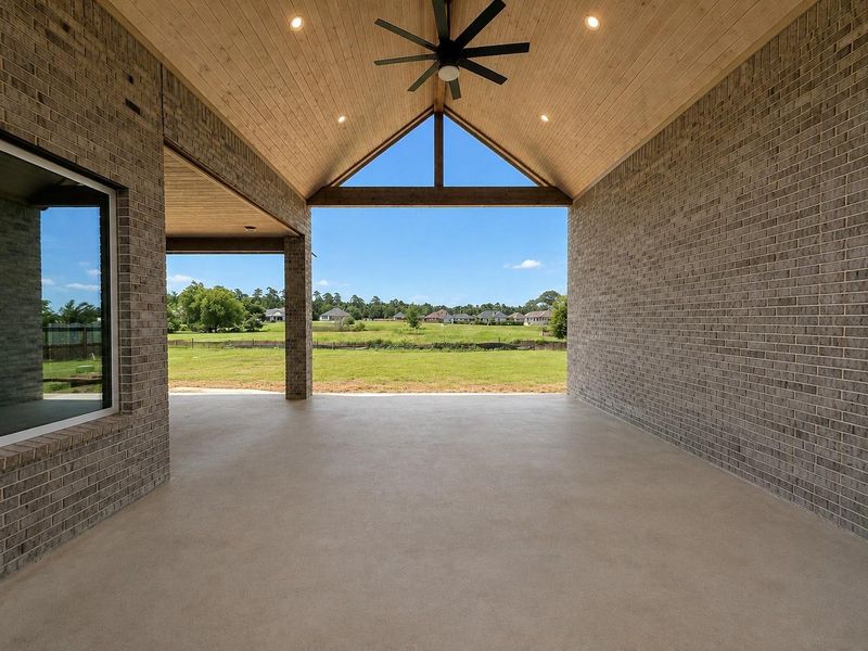 Oversized covered patio with soaring ceilings