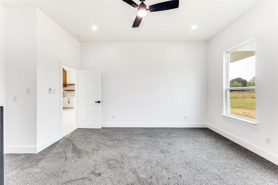 Empty room with carpet flooring, ceiling fan, and recessed lighting Empty room with carpet flooring, ceiling fan, and recessed lighting